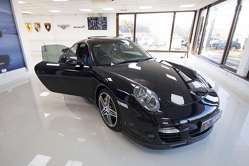 Black Porsche 911 turbo with door open